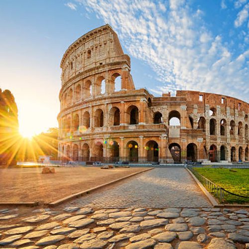 View of Colosseum in Rome and morning sun, Italy, Europe.